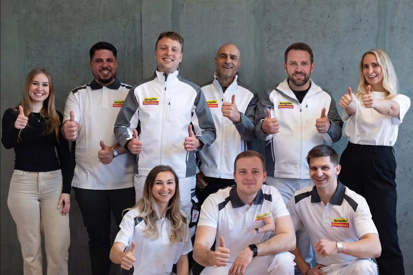 Das motivierte Team von Markgräfler Malermeisterbetrieb, bestehend aus neun Mitarbeitern, zeigt stolz Daumen hoch